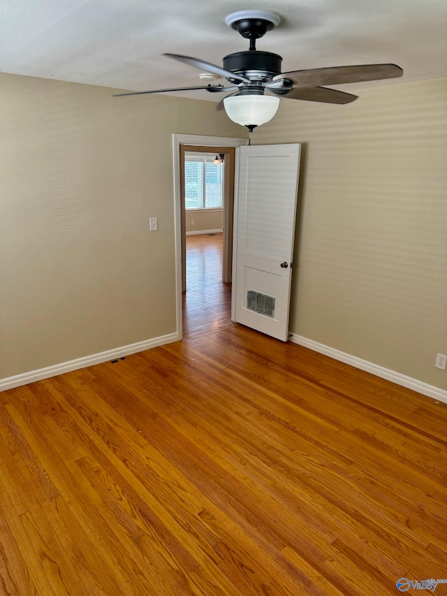 spare room featuring ceiling fan and light hardwood / wood-style floors