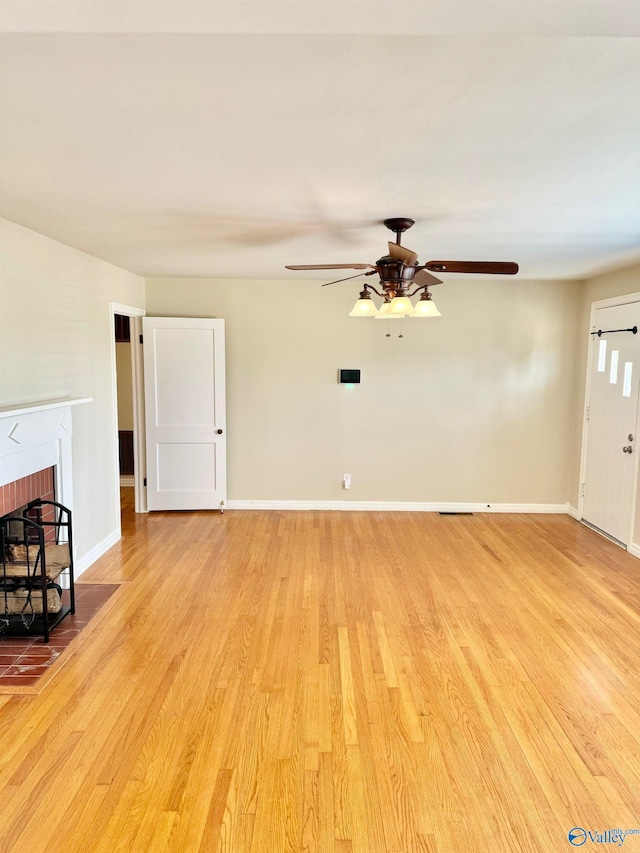 514 Marsheutz Ave SW, Huntsville, AL 35801 - unfurnished living room featuring baseboards, a ceiling fan, wood finished floors, and a fireplace