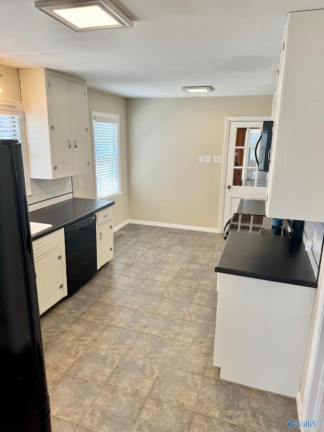 514 Marsheutz Ave SW, Huntsville, AL 35801 - kitchen with baseboards, backsplash, dark countertops, white cabinets, and black appliances