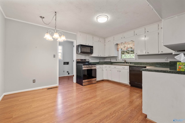 kitchen featuring white cabinetry, light wood-type flooring, black appliances, and plenty of natural light