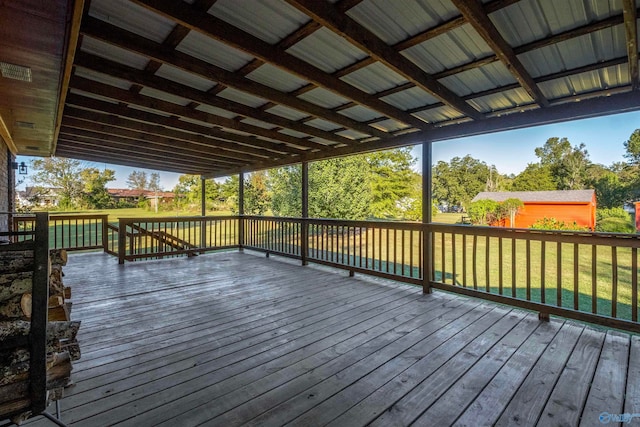 wooden deck featuring a lawn