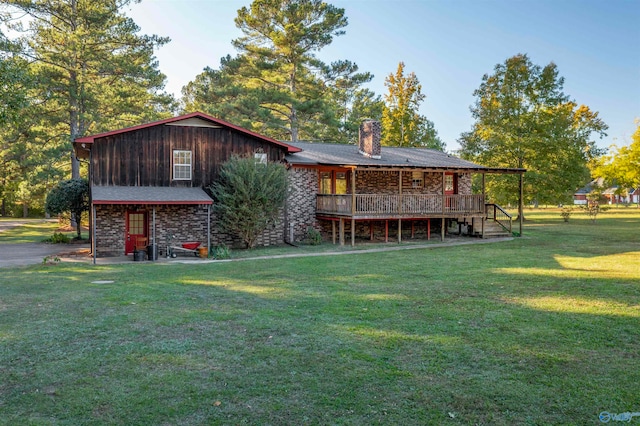 back of house featuring a deck and a lawn