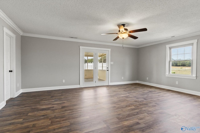 spare room featuring dark hardwood / wood-style flooring, a wealth of natural light, ceiling fan, and a textured ceiling