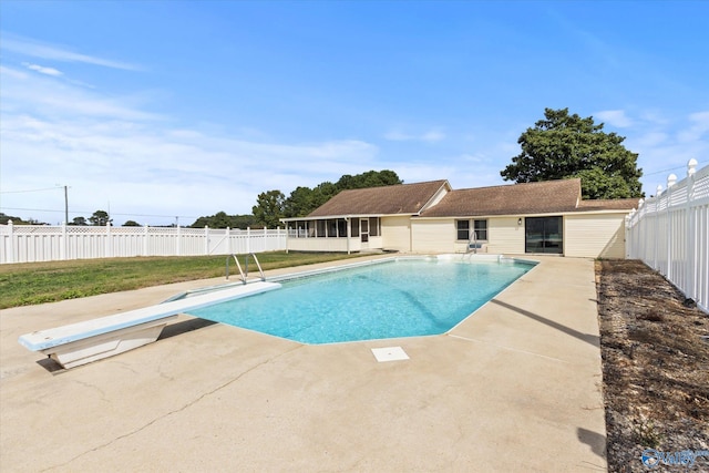 view of pool with a diving board and a patio area