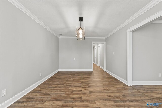 interior space featuring wood-type flooring, crown molding, and a textured ceiling