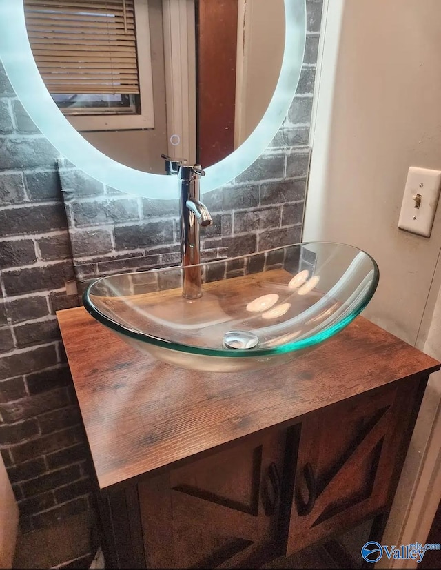 interior details featuring decorative backsplash and vanity