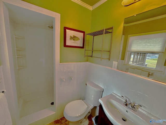 bathroom with walk in shower, sink, toilet, and crown molding