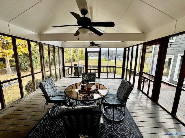 sunroom with ceiling fan and vaulted ceiling