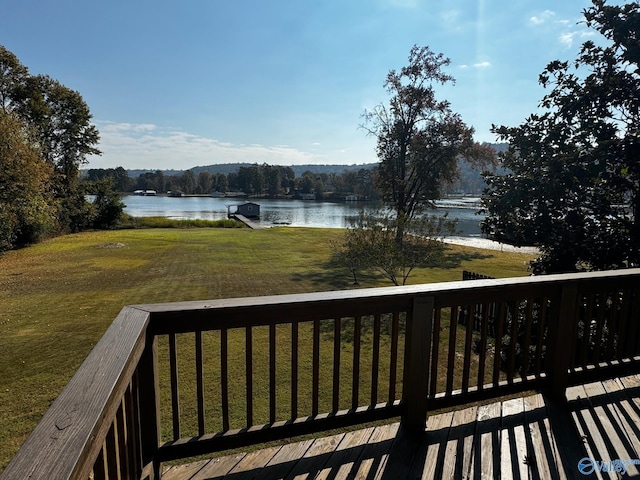 wooden terrace with a lawn and a water view