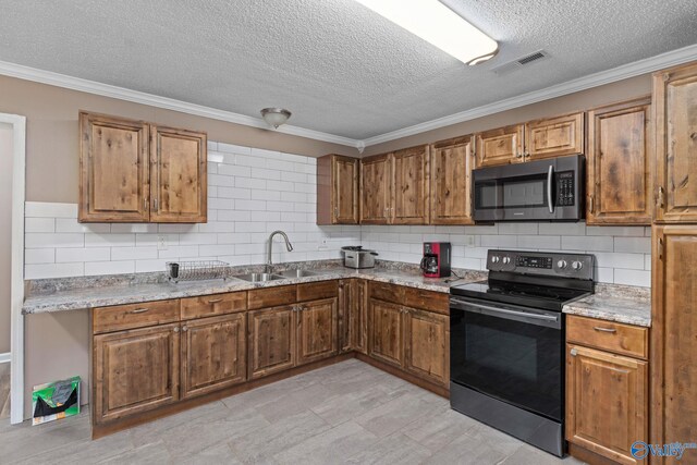 kitchen featuring stainless steel appliances, visible vents, brown cabinetry, ornamental molding, and a sink