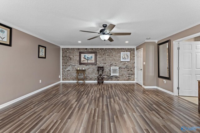 unfurnished living room featuring a textured ceiling, brick wall, and wood finished floors