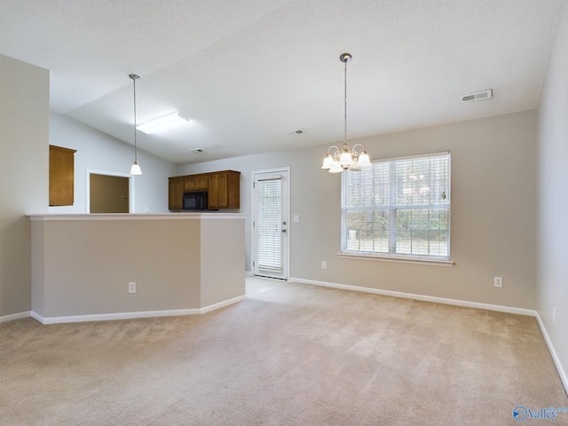 interior space featuring pendant lighting, lofted ceiling, light carpet, and a chandelier