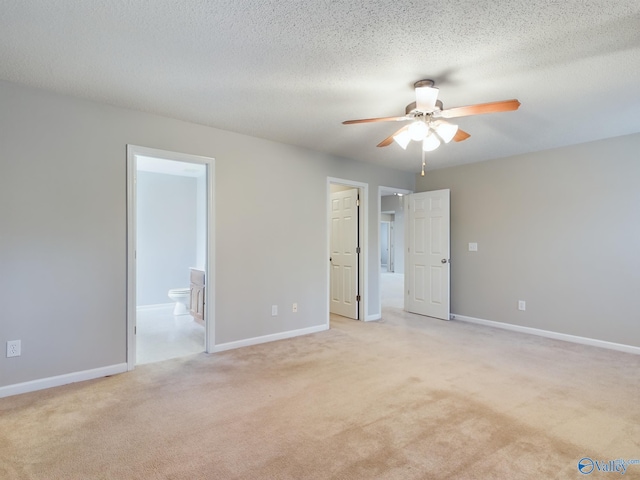 empty room featuring light carpet, a textured ceiling, and ceiling fan