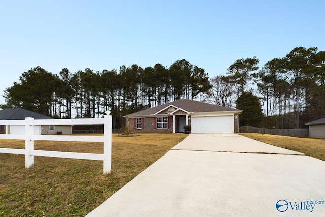 ranch-style house featuring a front lawn and a garage