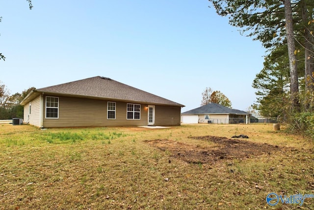 rear view of house with a yard and cooling unit