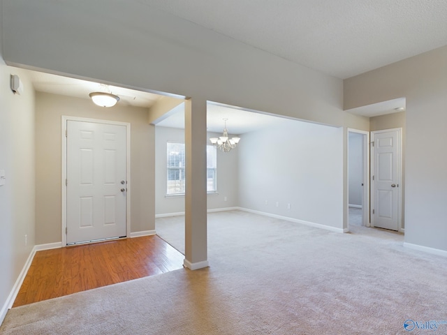 foyer entrance featuring light hardwood / wood-style flooring and a chandelier