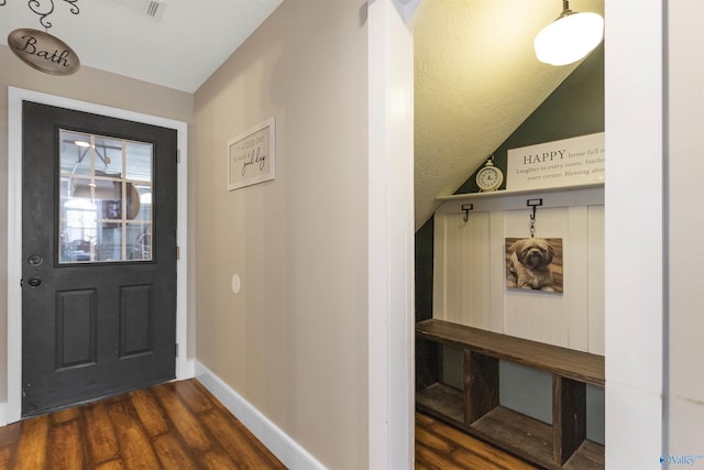 interior space featuring dark hardwood / wood-style flooring and vaulted ceiling