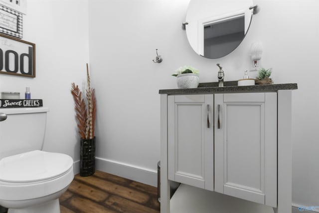 bathroom featuring vanity, toilet, and wood-type flooring