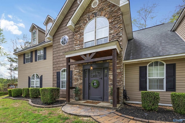 view of exterior entry with a lawn