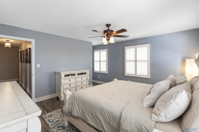 bedroom with ceiling fan and dark hardwood / wood-style flooring