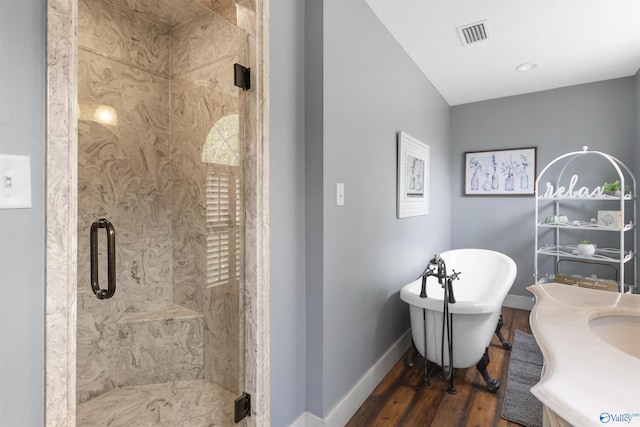 bathroom featuring vanity, shower with separate bathtub, and hardwood / wood-style floors