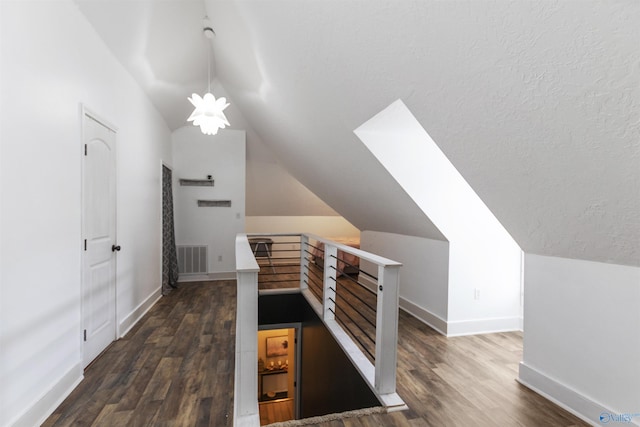 bonus room with vaulted ceiling, dark hardwood / wood-style floors, and a textured ceiling