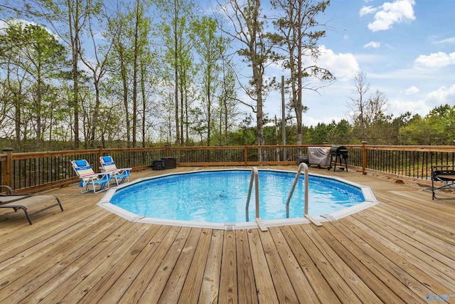 view of swimming pool featuring a deck