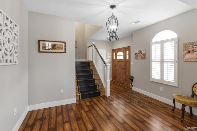 entrance foyer with a notable chandelier and dark wood-type flooring