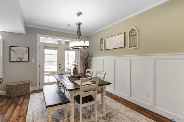 dining area with french doors, ornamental molding, and hardwood / wood-style floors