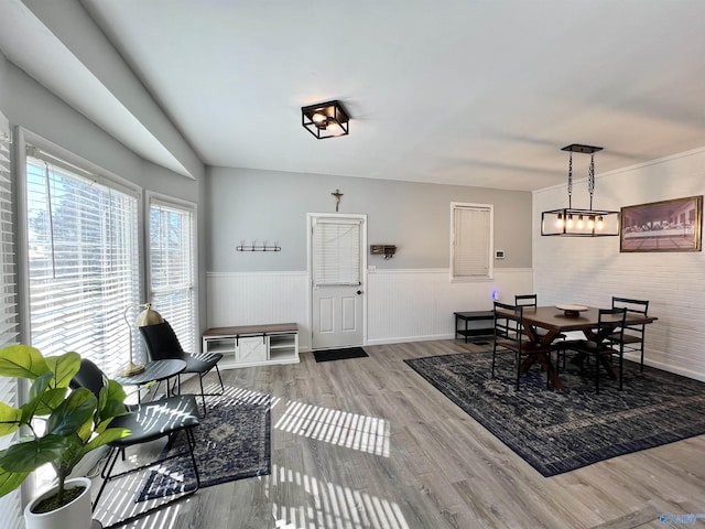 dining room featuring a wainscoted wall and wood finished floors