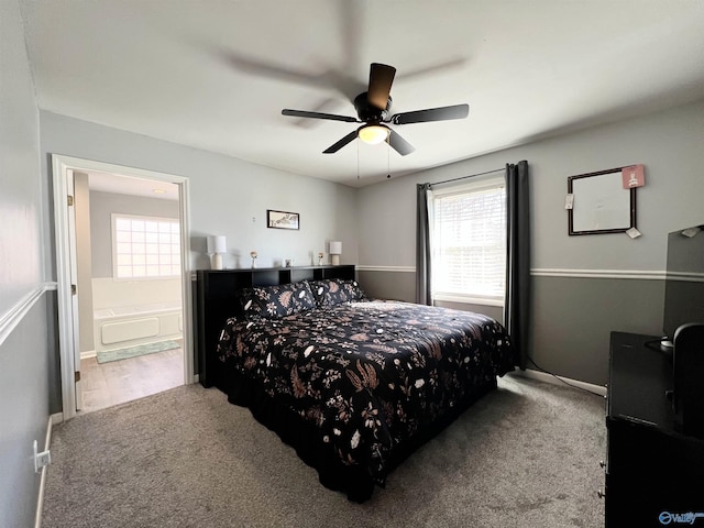 carpeted bedroom featuring ceiling fan and ensuite bathroom