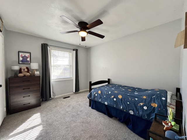 bedroom with ceiling fan, carpet, visible vents, and baseboards