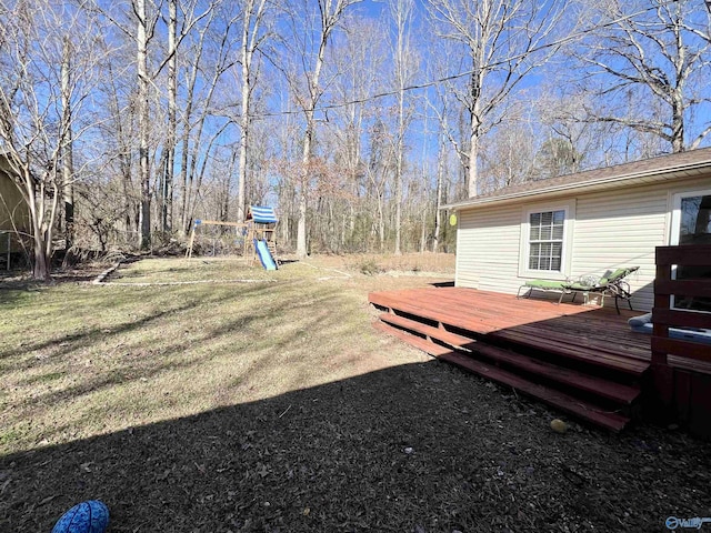 view of yard featuring a deck and a playground