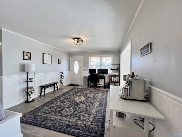 office with a wainscoted wall, crown molding, and wood finished floors