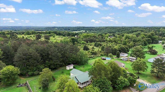 birds eye view of property with a wooded view