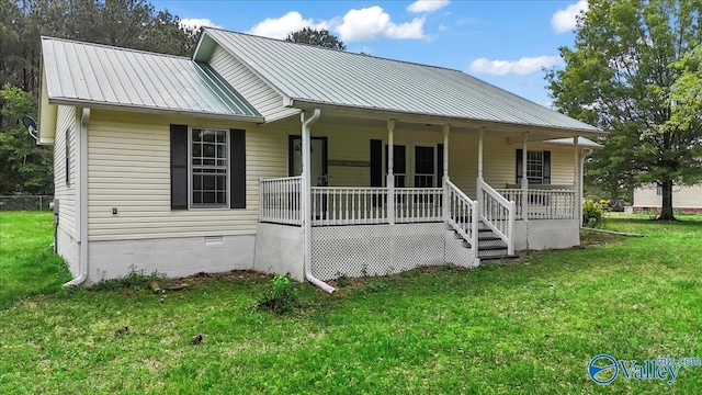 view of front facade with a front lawn, metal roof, and covered porch