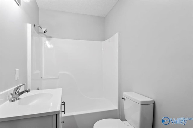 bathroom featuring toilet,  shower combination, vanity, and a textured ceiling