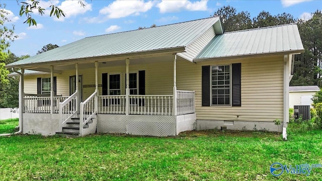 view of front of property featuring metal roof, central air condition unit, crawl space, a front yard, and a porch