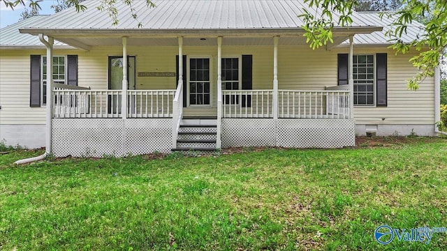 rear view of property with covered porch, crawl space, and a lawn