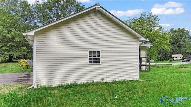 view of property exterior with a yard and central AC unit
