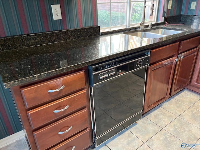 kitchen featuring sink, light tile patterned flooring, dark stone counters, and black dishwasher