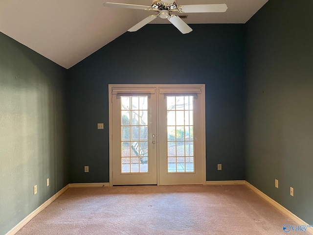 carpeted empty room with french doors, ceiling fan, and lofted ceiling