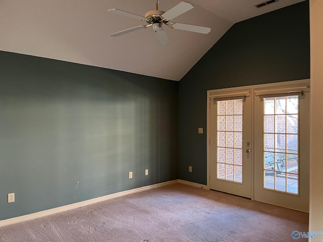 empty room featuring ceiling fan, lofted ceiling, light carpet, and french doors