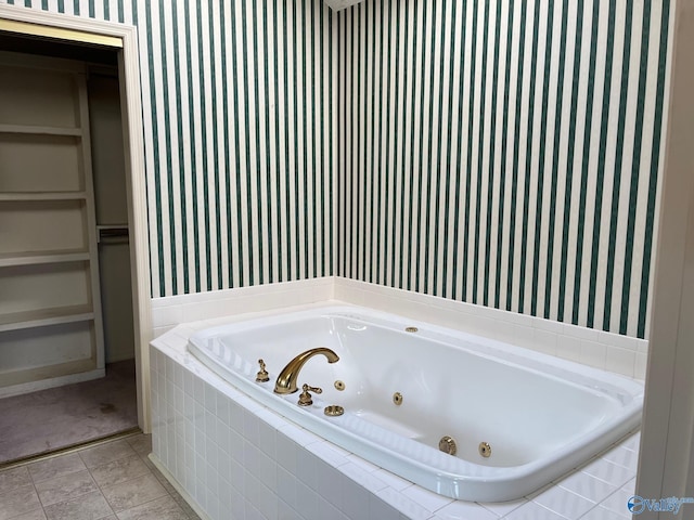 bathroom featuring tile patterned flooring and tiled bath