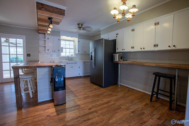 kitchen with dishwasher, stainless steel fridge with ice dispenser, butcher block countertops, a kitchen bar, and white cabinetry