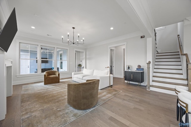 living room with crown molding, hardwood / wood-style floors, and a notable chandelier