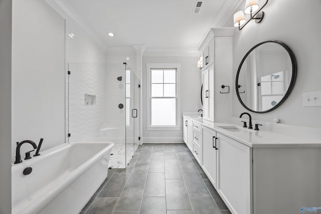 bathroom featuring crown molding, separate shower and tub, vanity, and tile patterned floors