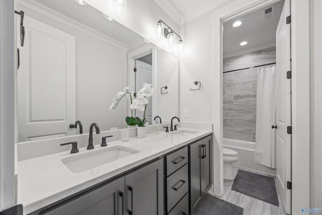 full bathroom featuring vanity, ornamental molding, shower / bath combination with curtain, and toilet