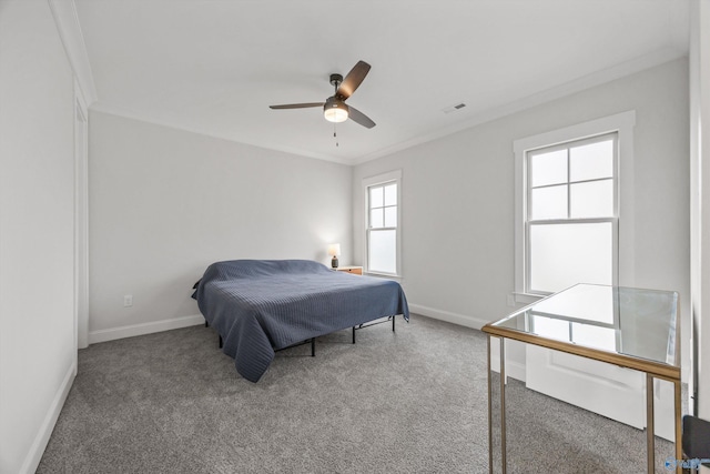 carpeted bedroom with ceiling fan and ornamental molding