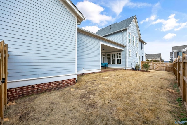 back of property with ceiling fan